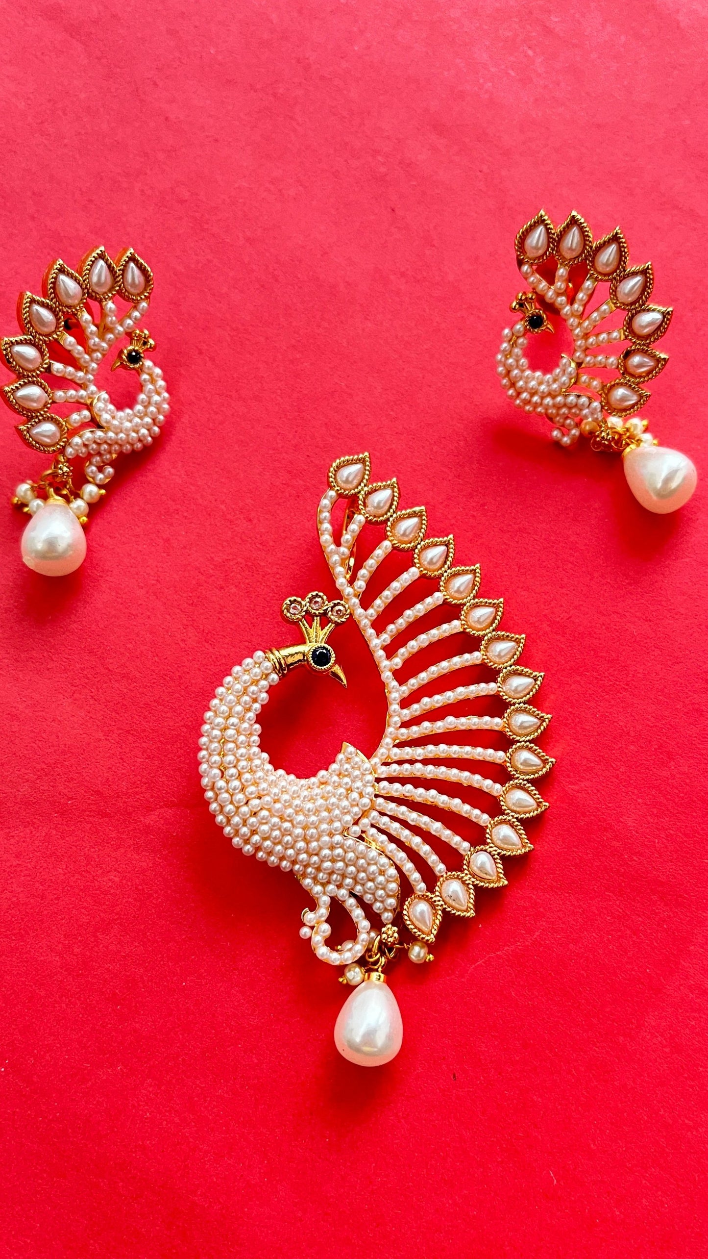 An elegant peacock pendant with matching earings with mala