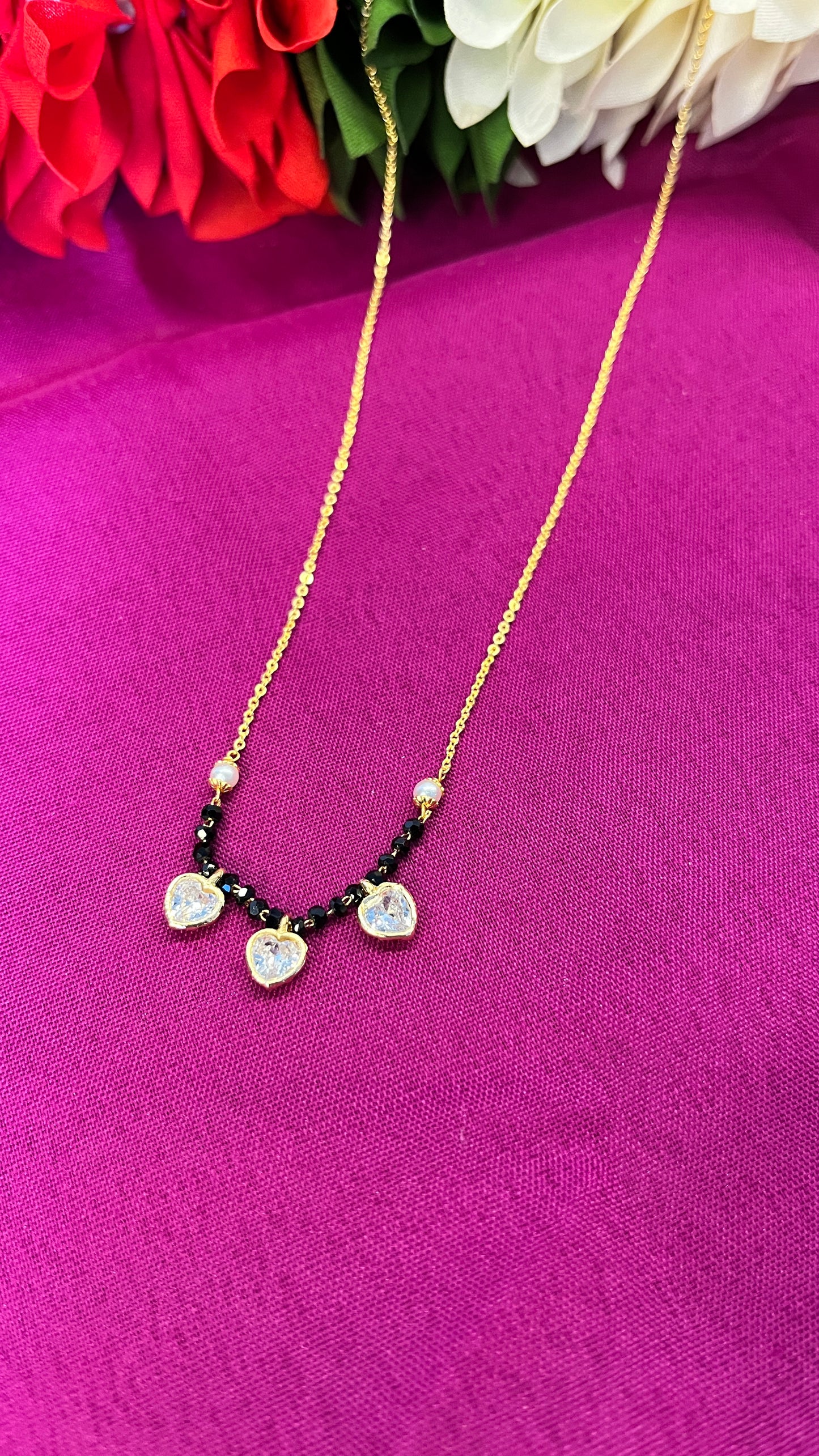 Menka Short Mangalsutra with three little hearts .