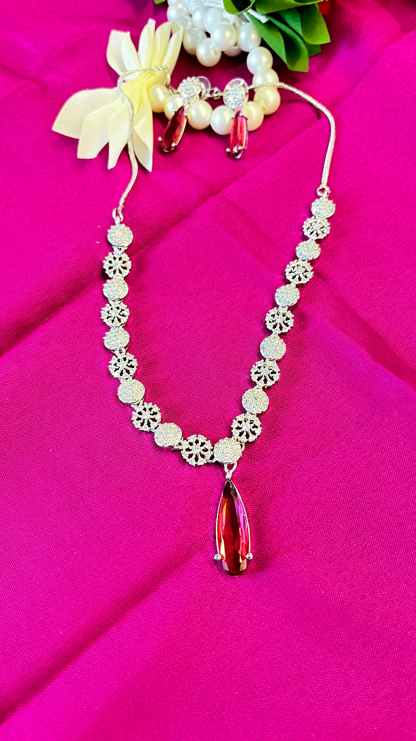 An elegant water droplet necklace with American Diamonds in pink colour