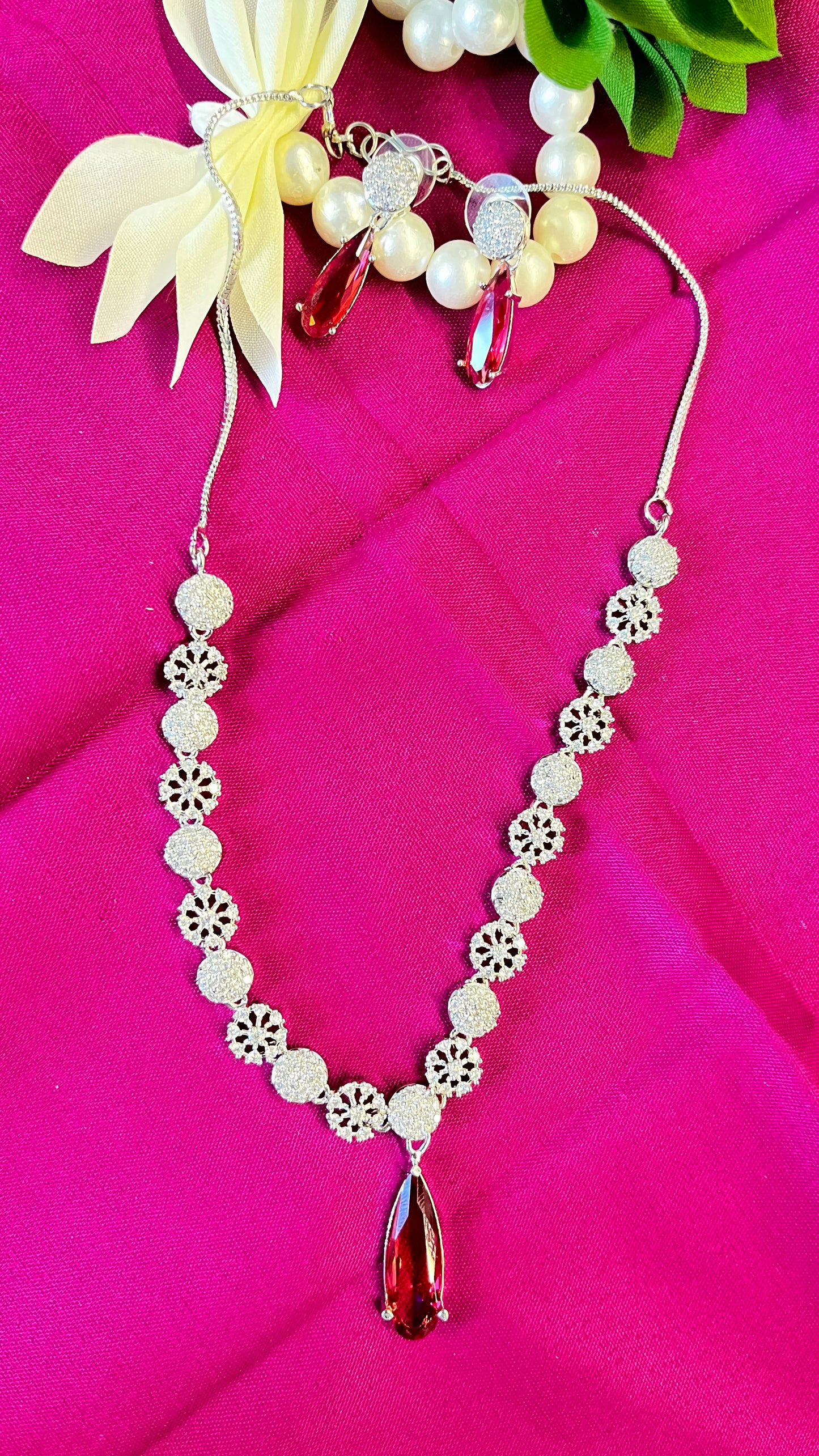 An elegant water droplet necklace with American Diamonds in pink colour