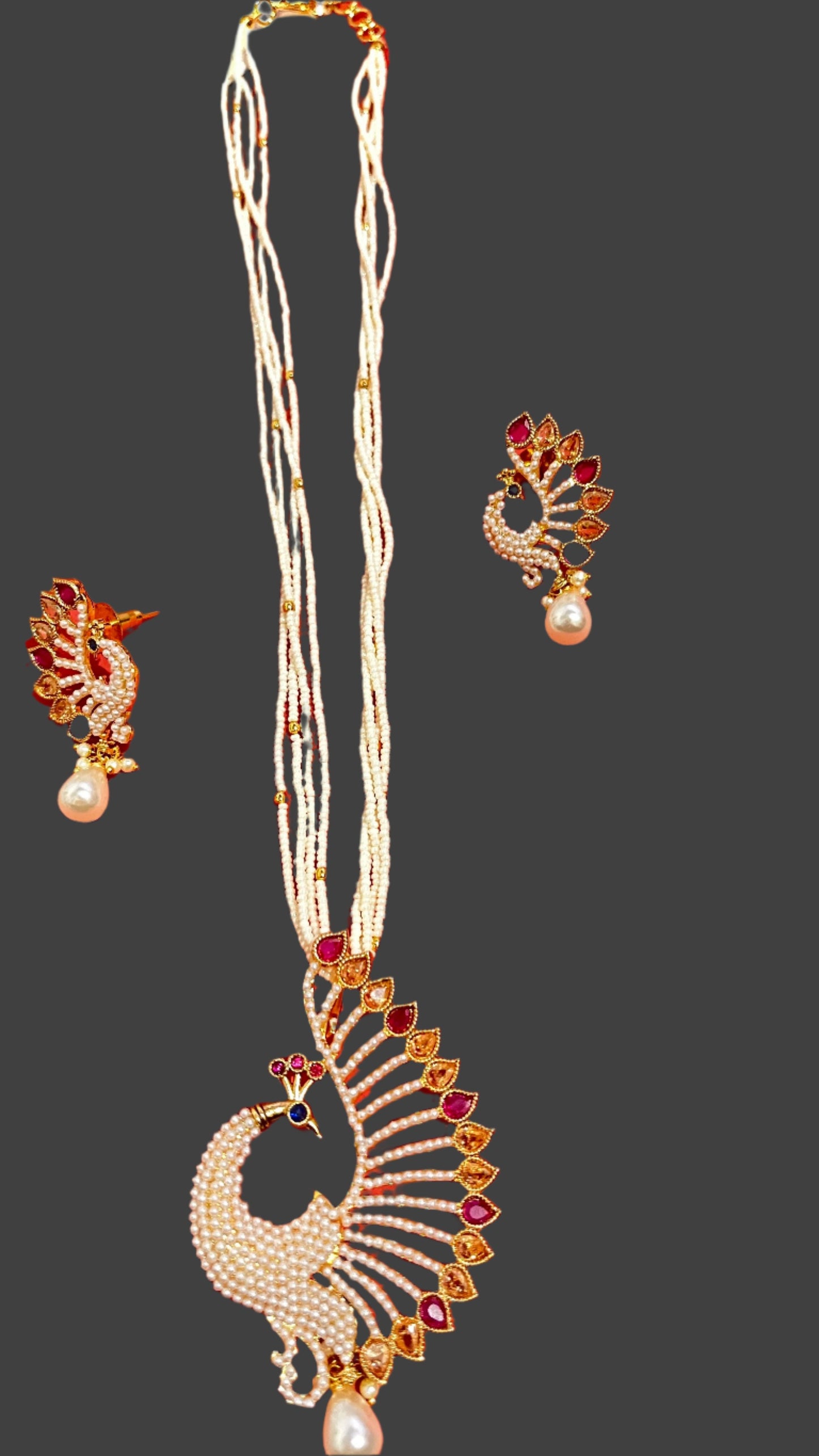 A multicolor peacock pendant with earings and a mala